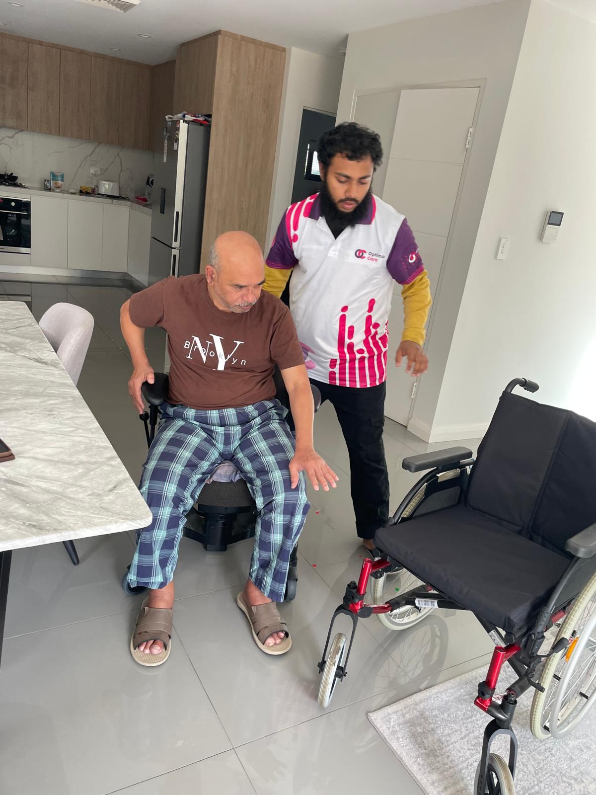 Participant practising walking with a frame while a support worker assists
