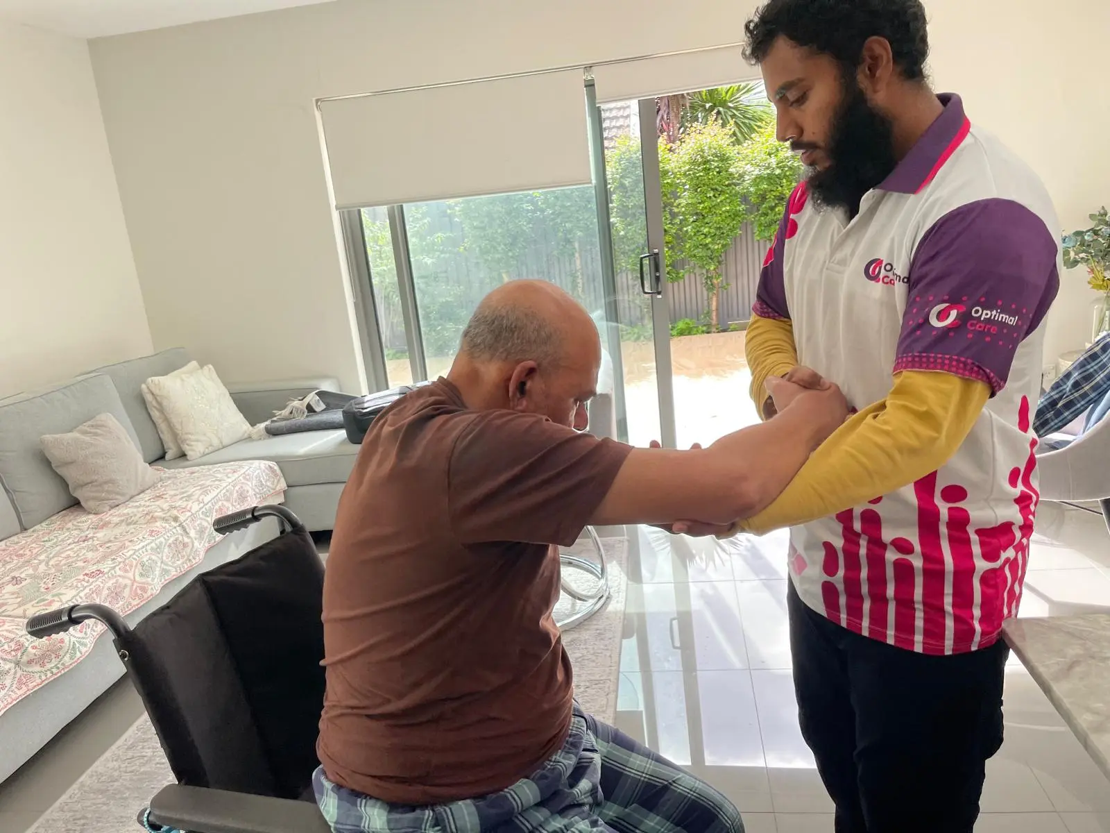 Support worker helping a participant at the table
