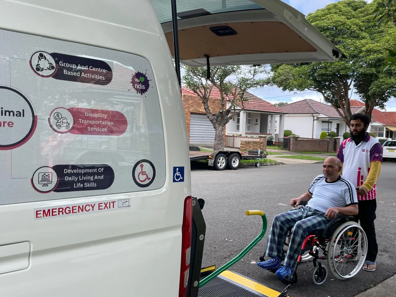 Support worker and participant using the accessible van's lift